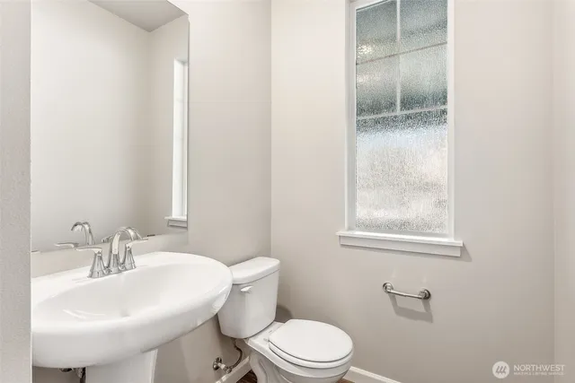 a bathroom with a sink toilet and a mirror