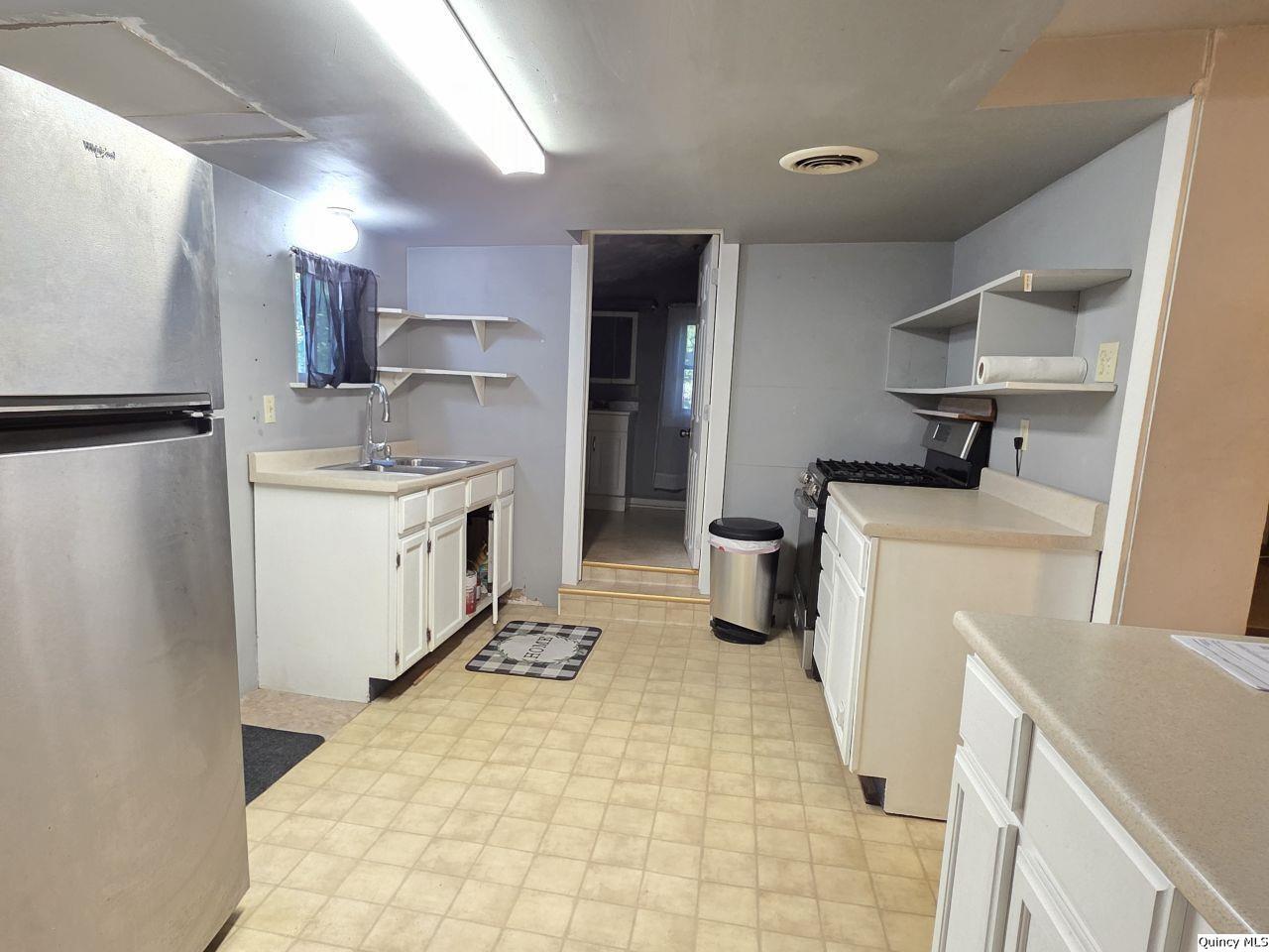 1717 North 4th Street Quincy, IL 62301 - Photo 4 of 8 a kitchen with a sink stove and refrigerator