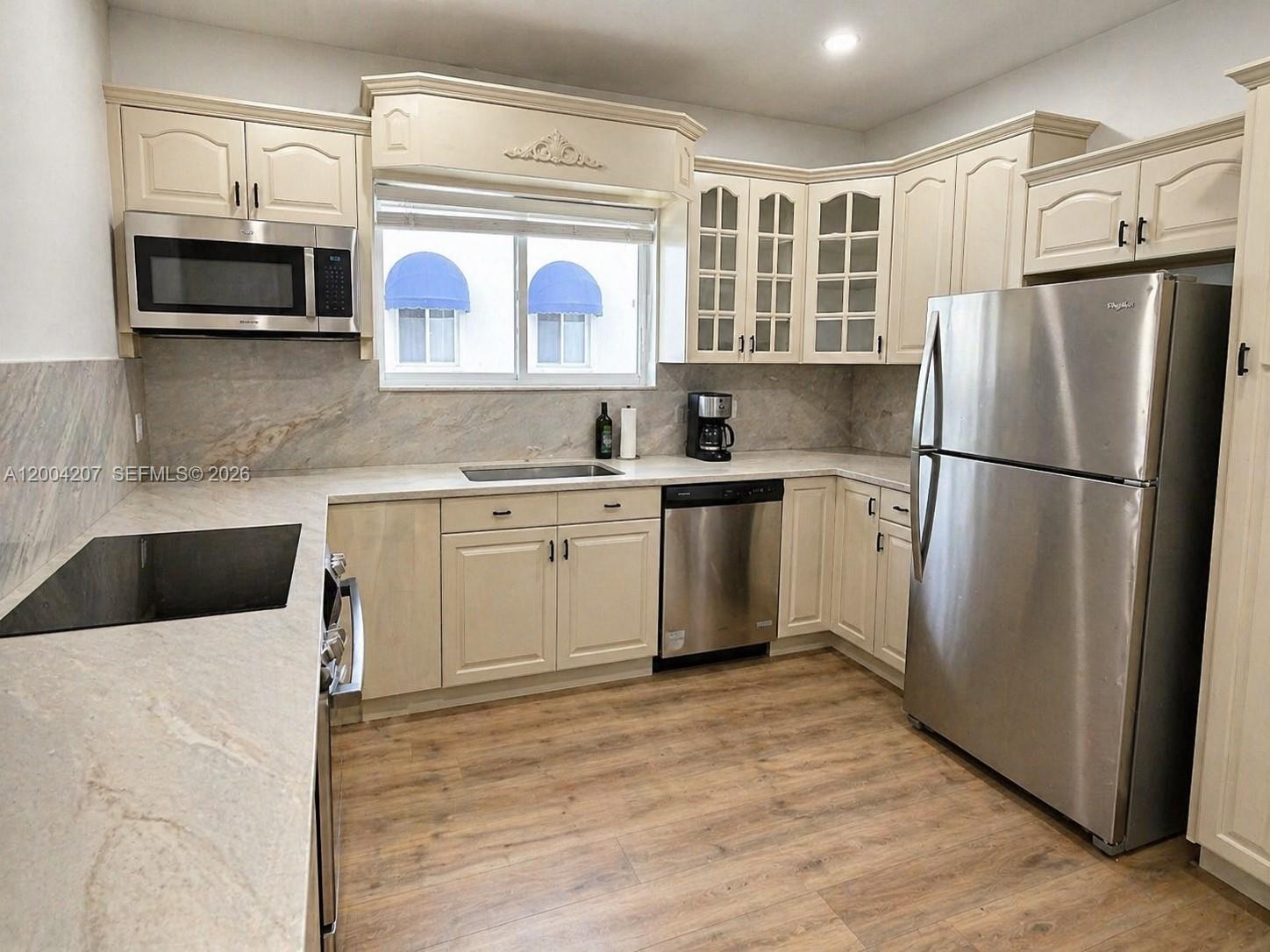 426 Southwest 26th Road Miami, FL 33129 - Photo 7 of 9 a kitchen with stainless steel appliances granite countertop a refrigerator sink and microwave