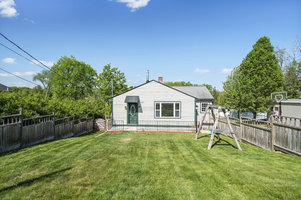 645 Nashua Road Dracut, MA 01826 - Photo 29 of 30 a front view of a house with a yard and trees