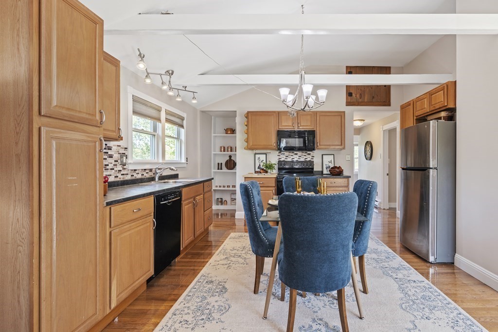 645 Nashua Road Dracut, MA 01826 - Photo 3 of 30 a kitchen with stainless steel appliances granite countertop a refrigerator a sink dishwasher a dining table and chairs with wooden floor