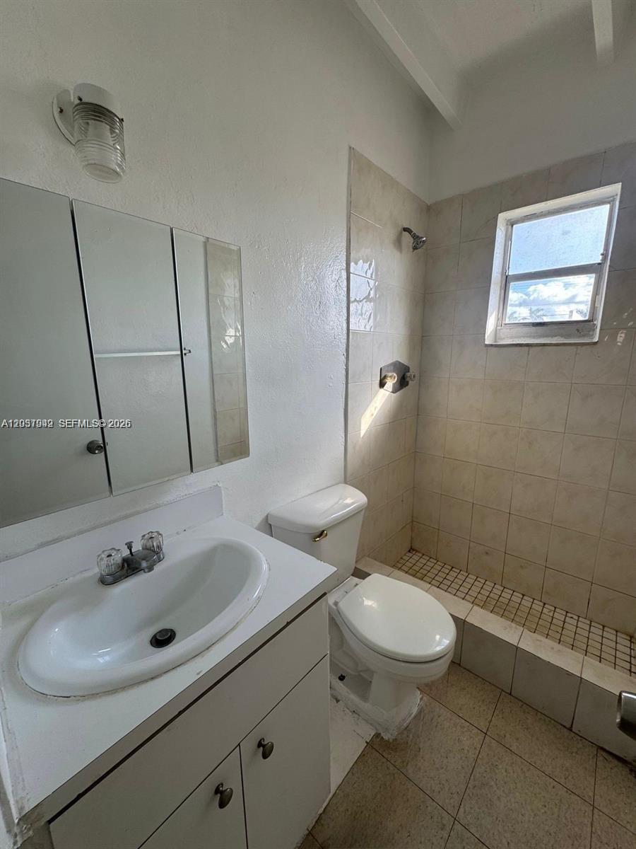 320 Southwest 11th Avenue, Unit 2 Homestead, FL 33030 - Photo 4 of 11 a bathroom with a toilet a sink and mirror