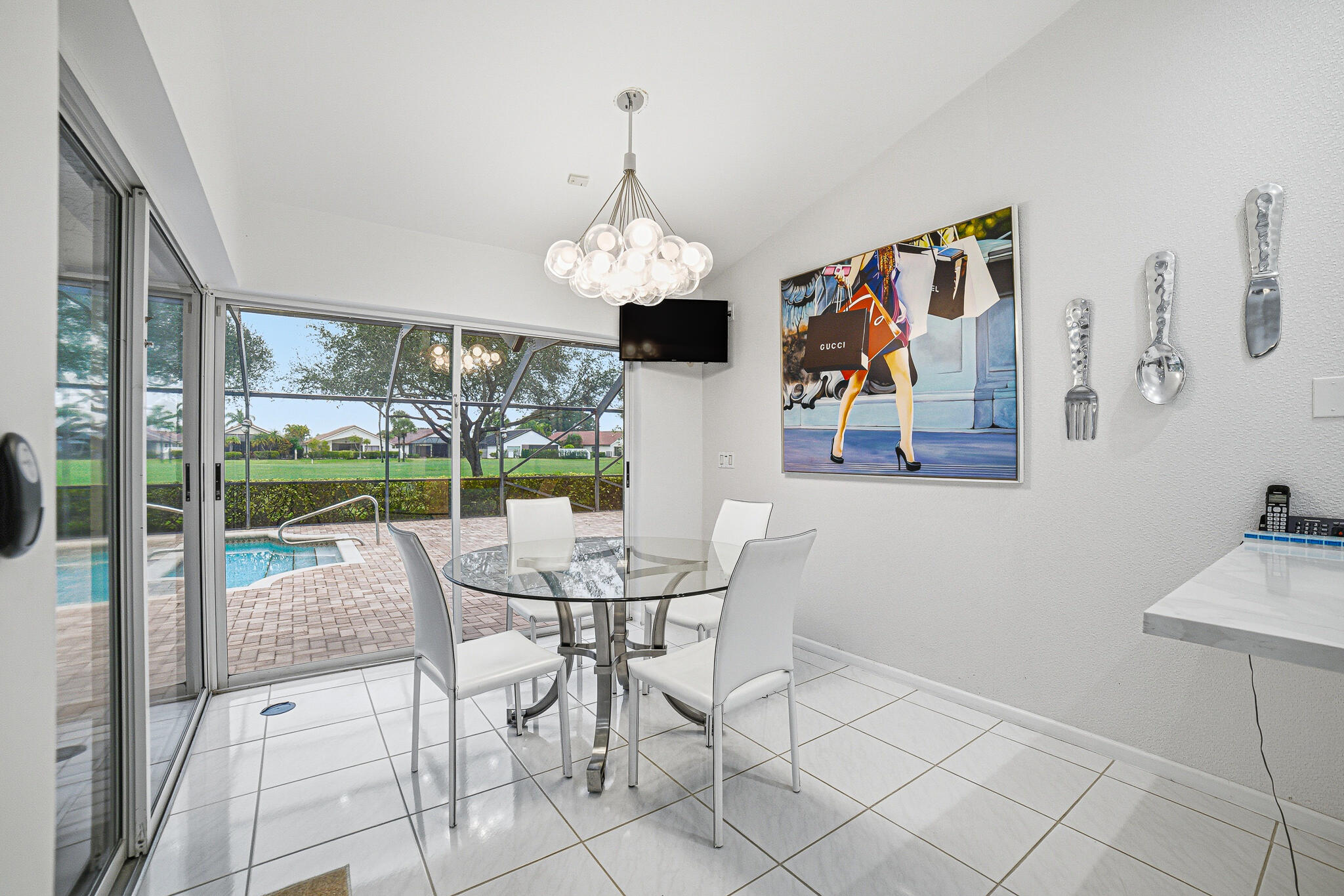 10791 River Glenn Drive Boca Raton, FL 33428 - Photo 19 of 68 a view of a dining room with furniture wooden floor and chandelier
