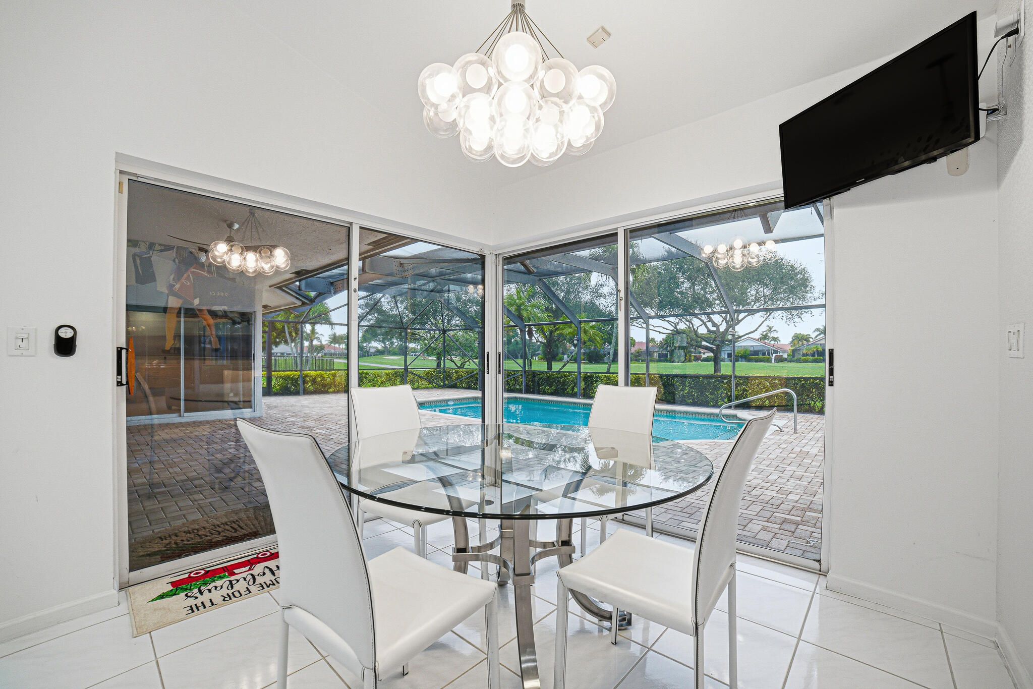 10791 River Glenn Drive Boca Raton, FL 33428 - Photo 20 of 68 a view of a dining room with furniture wooden floor and chandelier