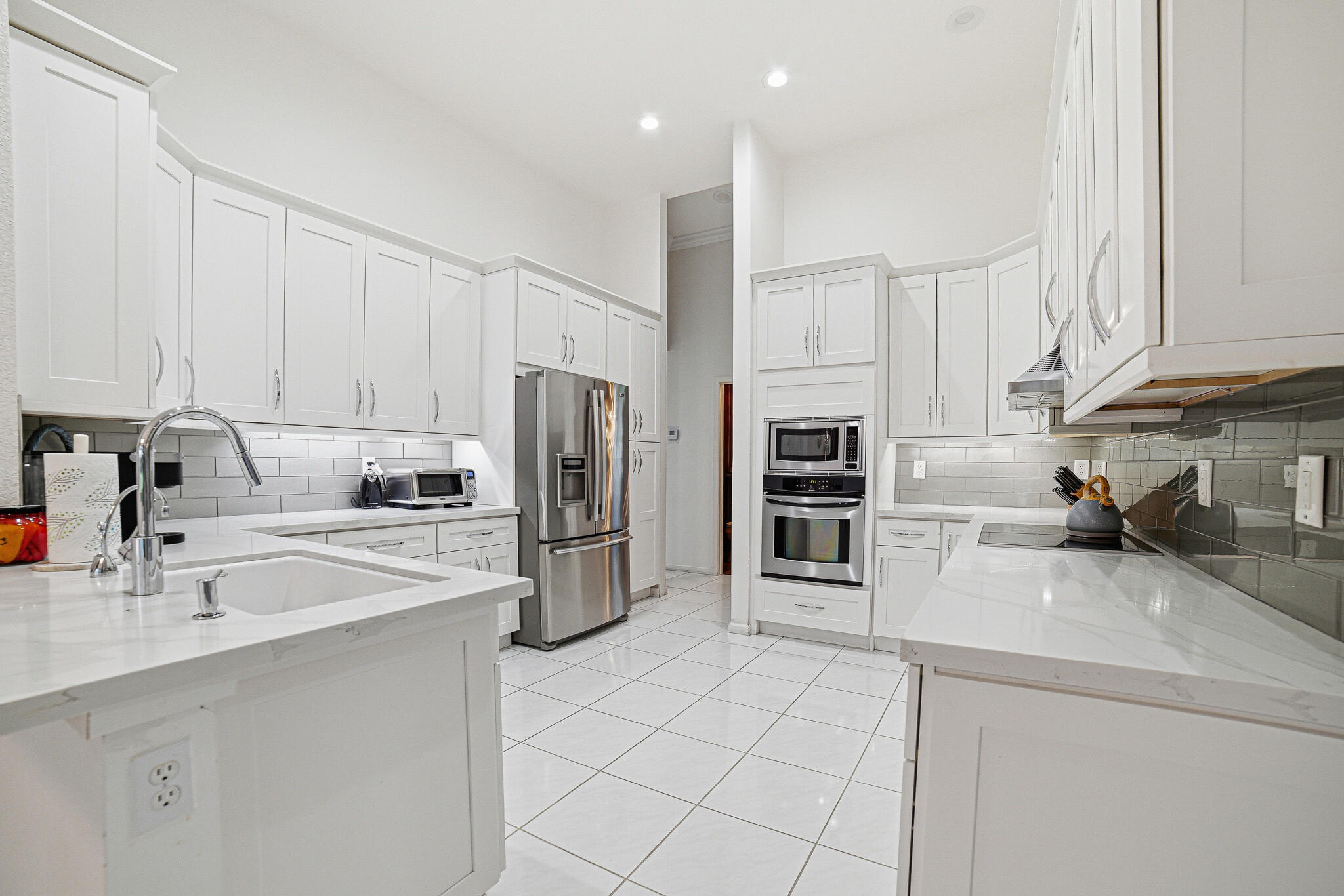 10791 River Glenn Drive Boca Raton, FL 33428 - Photo 21 of 68 a kitchen with refrigerator a sink and a counter top space