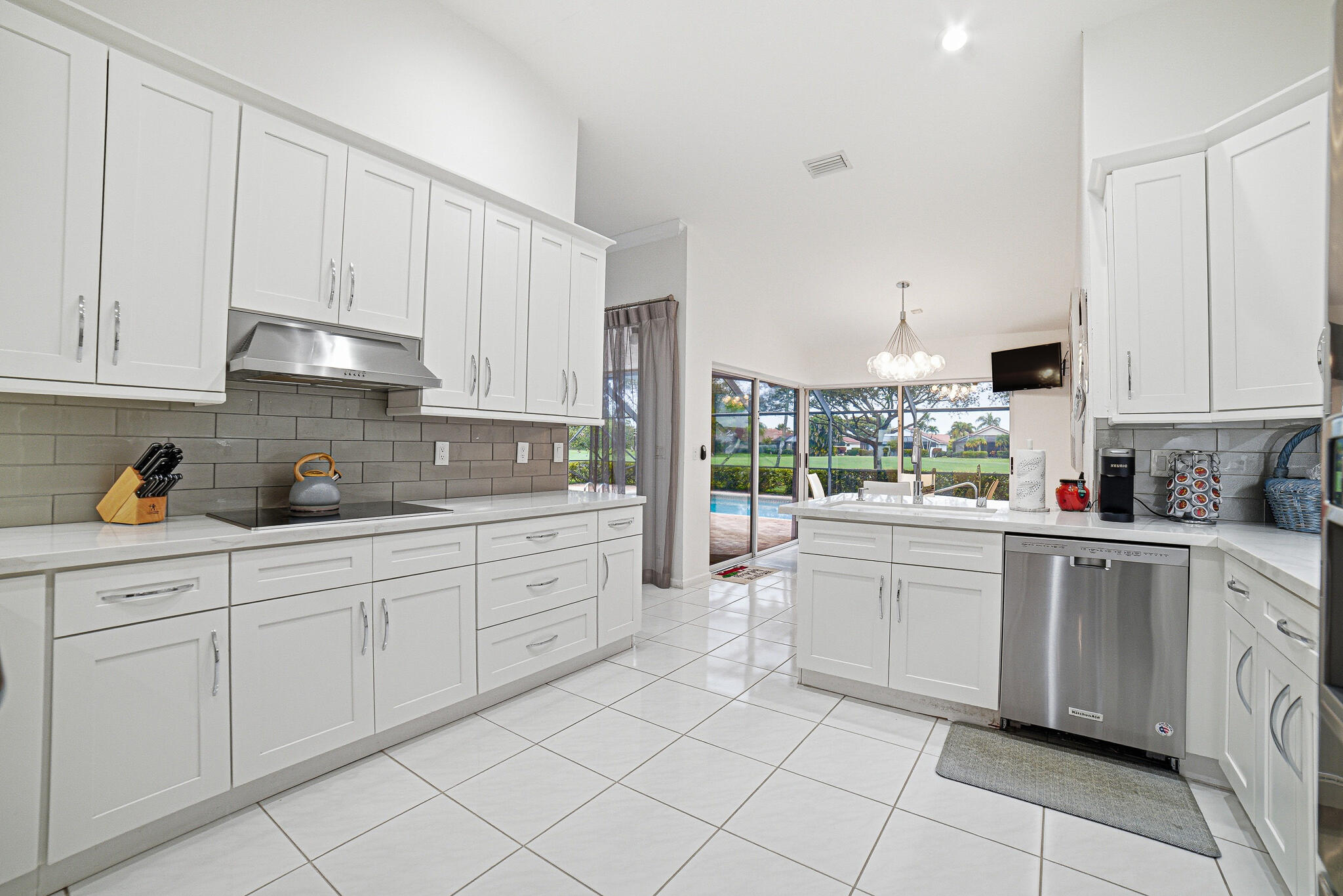 10791 River Glenn Drive Boca Raton, FL 33428 - Photo 23 of 68 a kitchen with white cabinets and white appliances