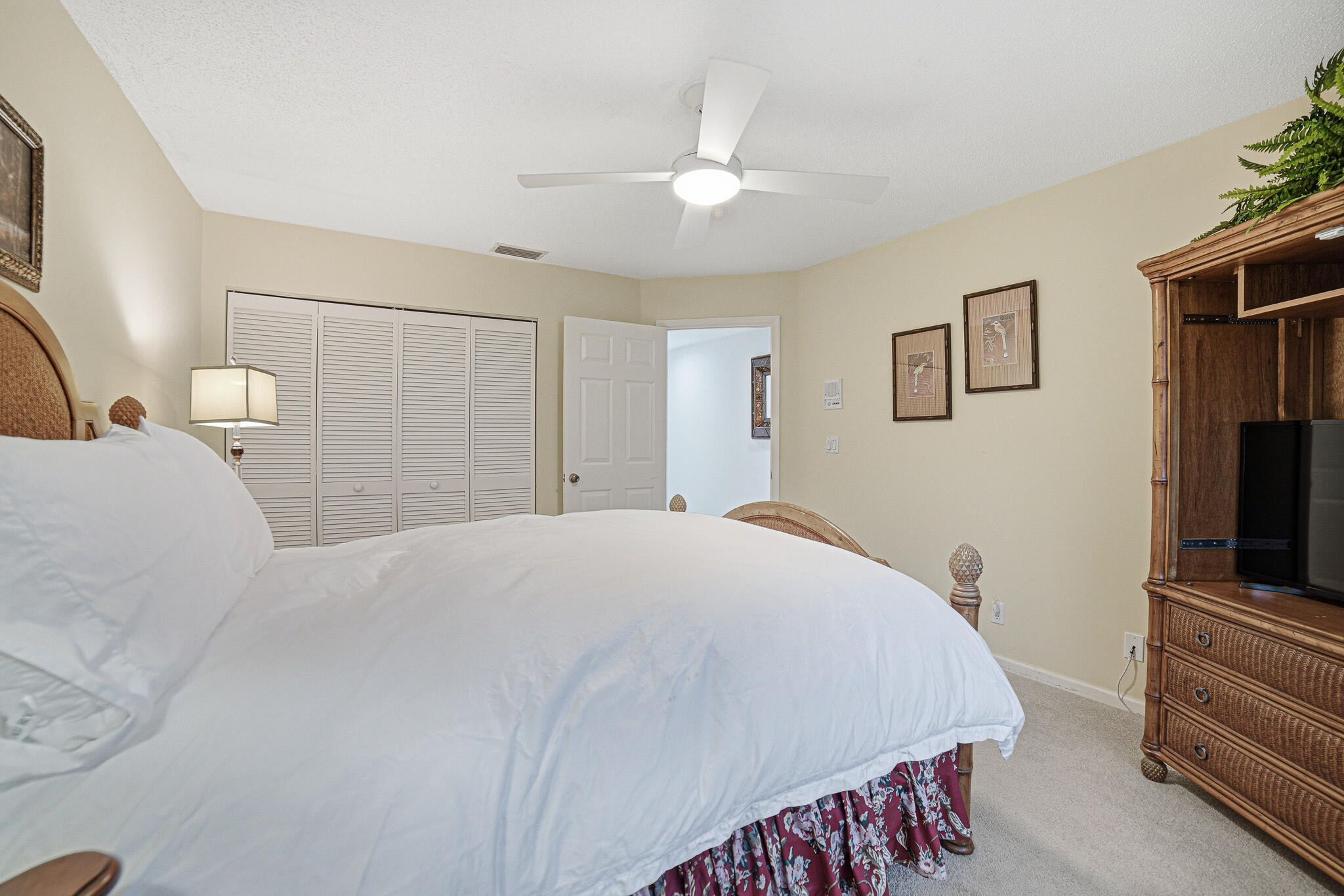 10791 River Glenn Drive Boca Raton, FL 33428 - Photo 35 of 68 a spacious bedroom with a bed and a flat screen tv