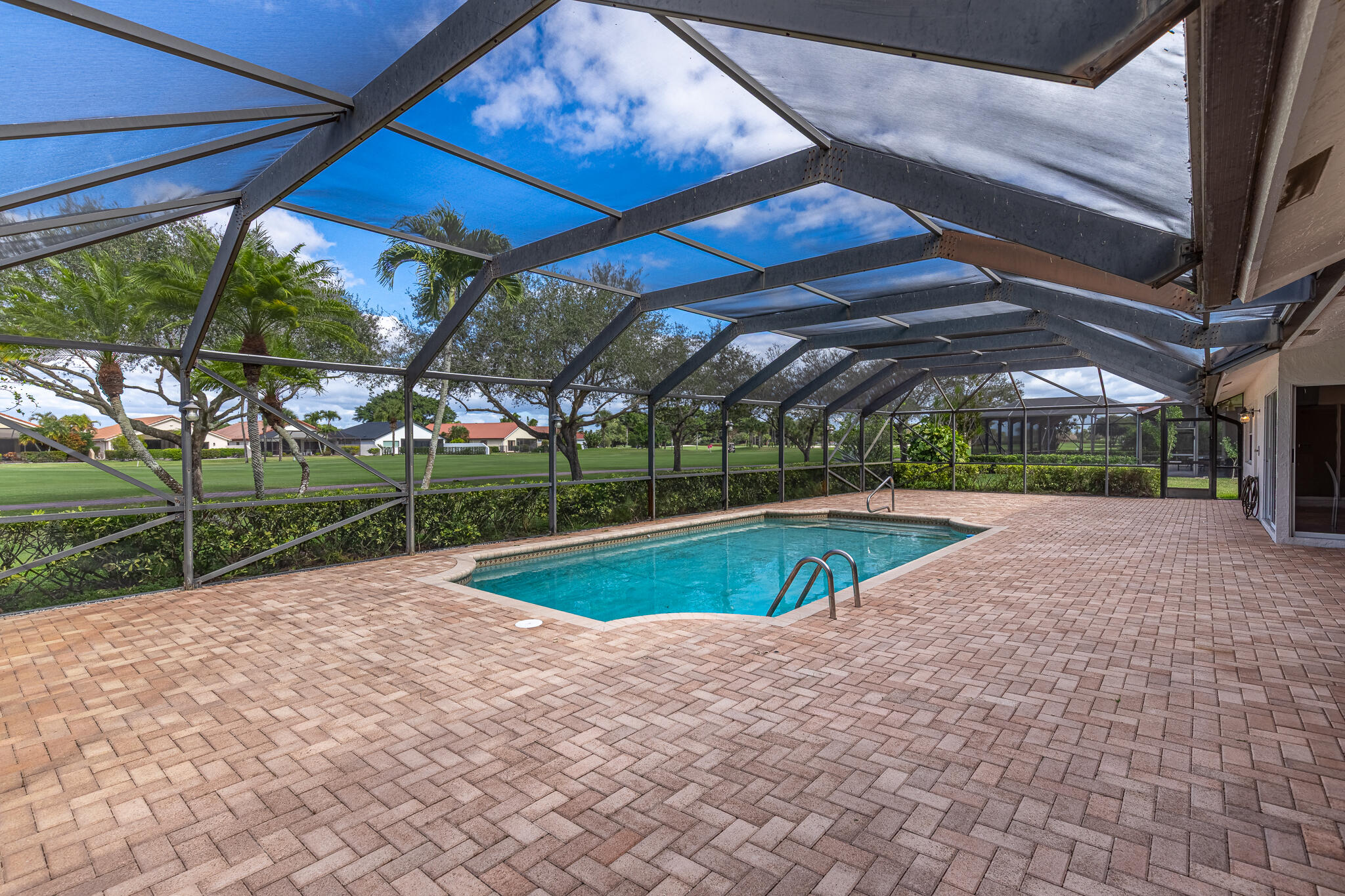 10791 River Glenn Drive Boca Raton, FL 33428 - Photo 4 of 68 a view of a backyard with table and chairs under an umbrella