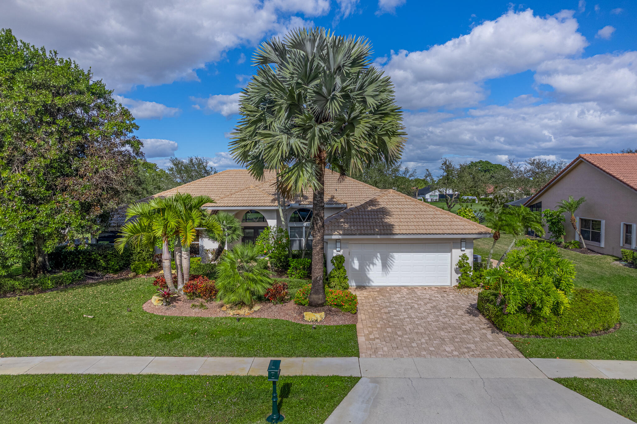 10791 River Glenn Drive Boca Raton, FL 33428 - Photo 44 of 68 a front view of a house with a garden