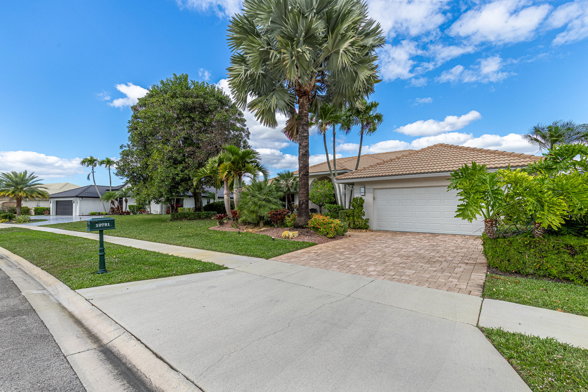 10791 River Glenn Drive Boca Raton, FL 33428 - Photo 47 of 68 a view of a house with a yard and palm trees