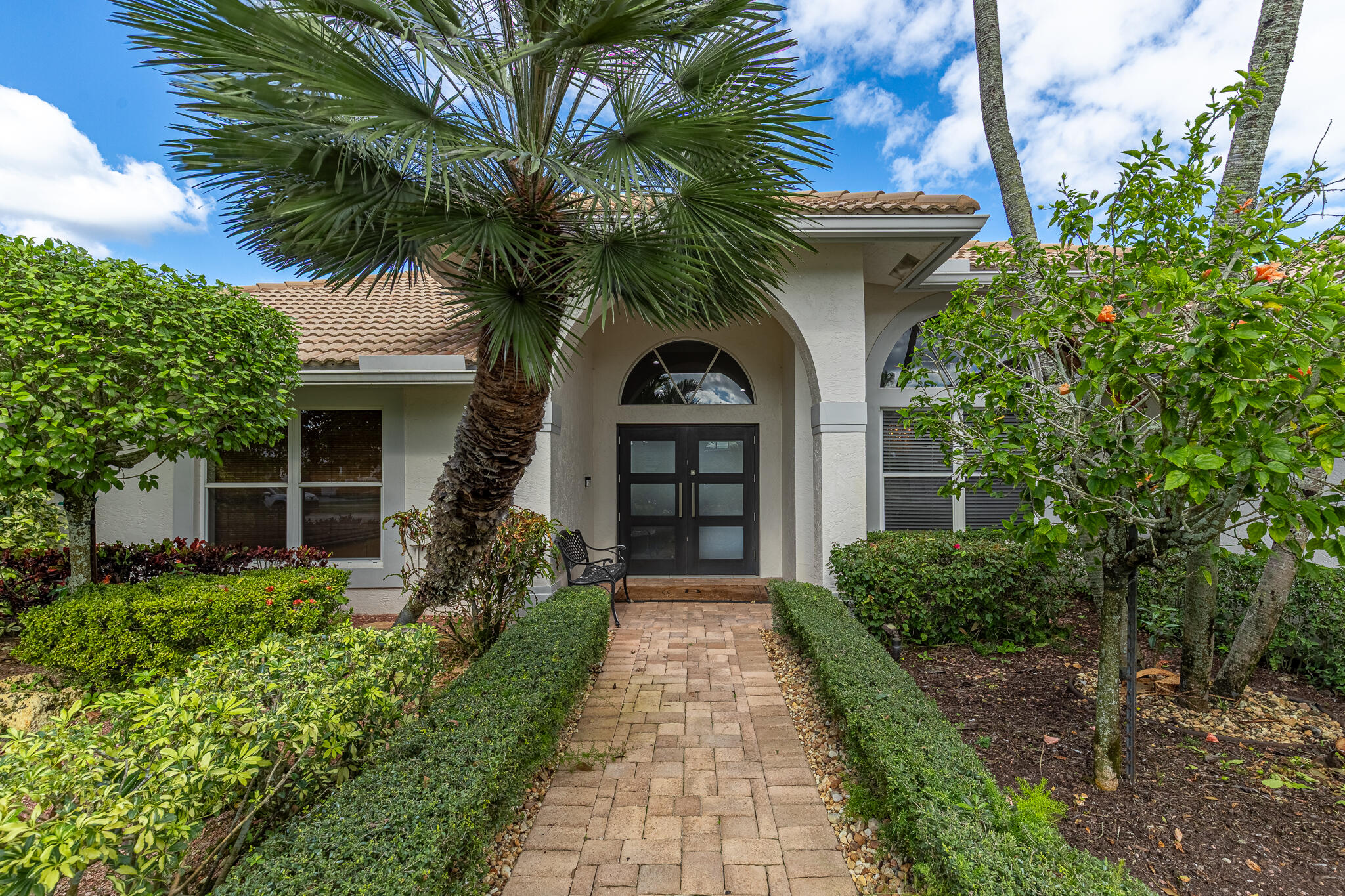10791 River Glenn Drive Boca Raton, FL 33428 - Photo 6 of 68 a front view of a house with a yard