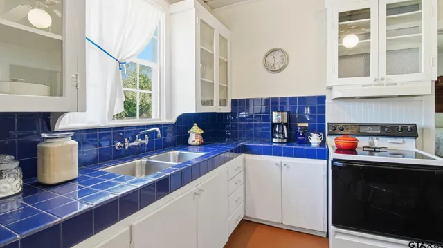 a kitchen with stainless steel appliances granite countertop a sink dishwasher stove and cabinets