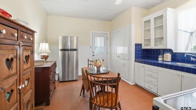 a living room with furniture a dining table and a window