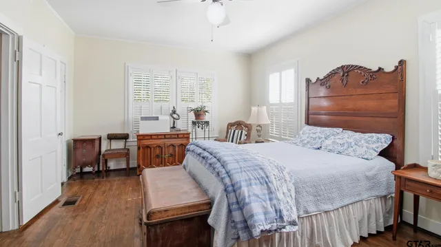 a bedroom with a bed and a table chair