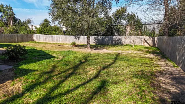 a swimming pool with outdoor seating and yard