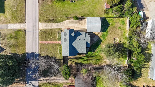 an aerial view of a house with a yard
