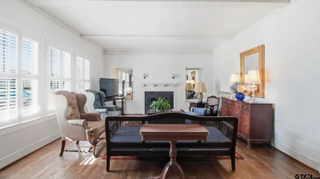 a living room with furniture a large window and a fireplace