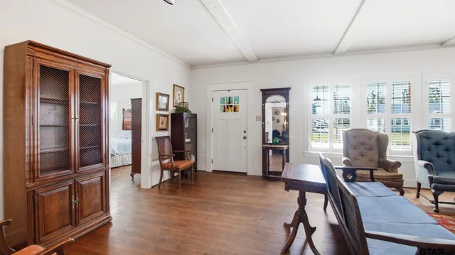 a view of a livingroom with workspace and a window