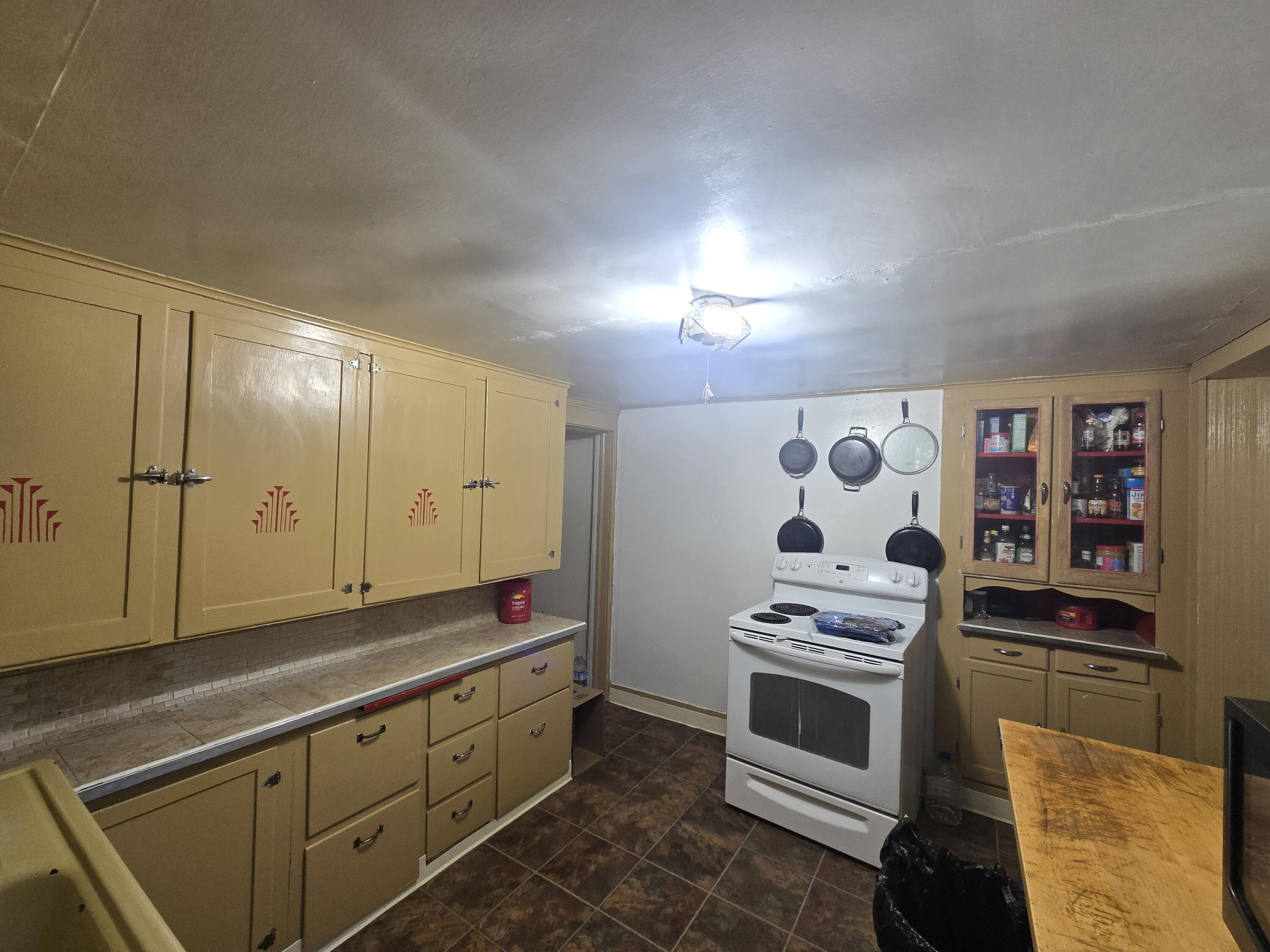 409 East Ash Street Chiloquin, OR 97624 - Photo 10 of 37 a kitchen with stainless steel appliances a stove and white cabinets