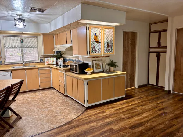 a view of a room with wooden floor and windows