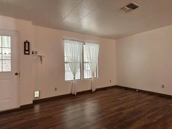 a view of an empty room with a door