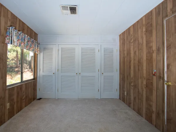 a view of a room with a wooden floor and a window