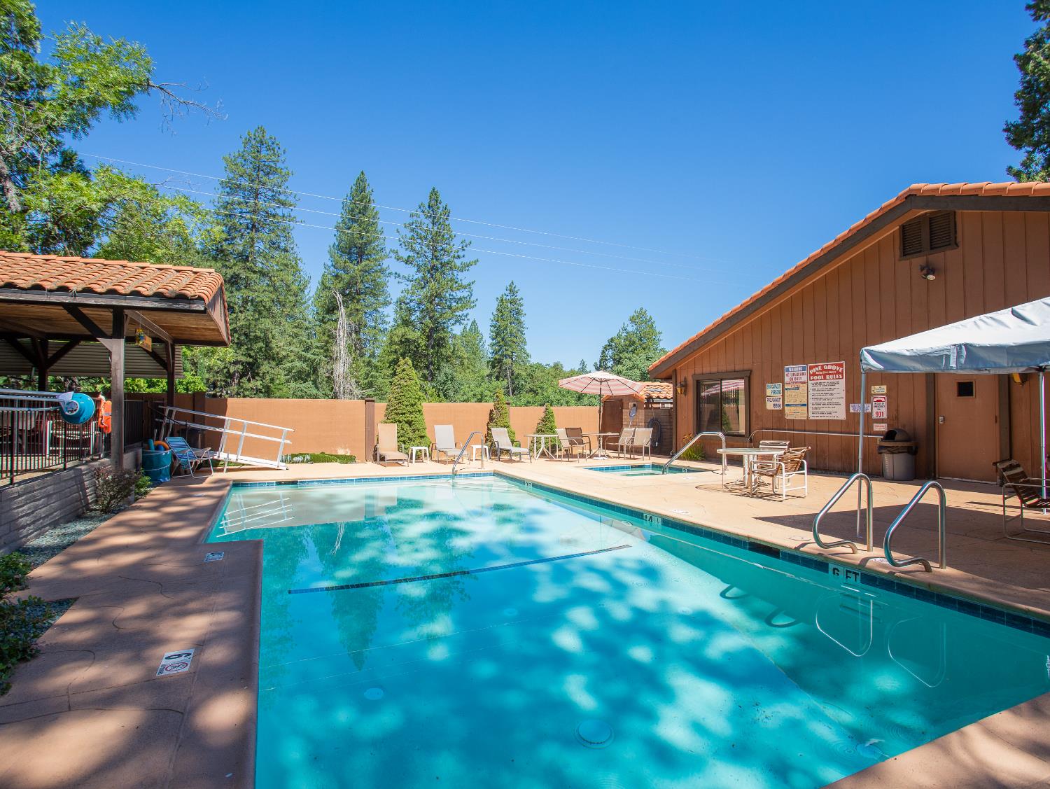14074 Irish Town Road, Unit 40 Pine Grove, CA 95665 - Photo 49 of 51 a view of a patio with table and chairs under an umbrella