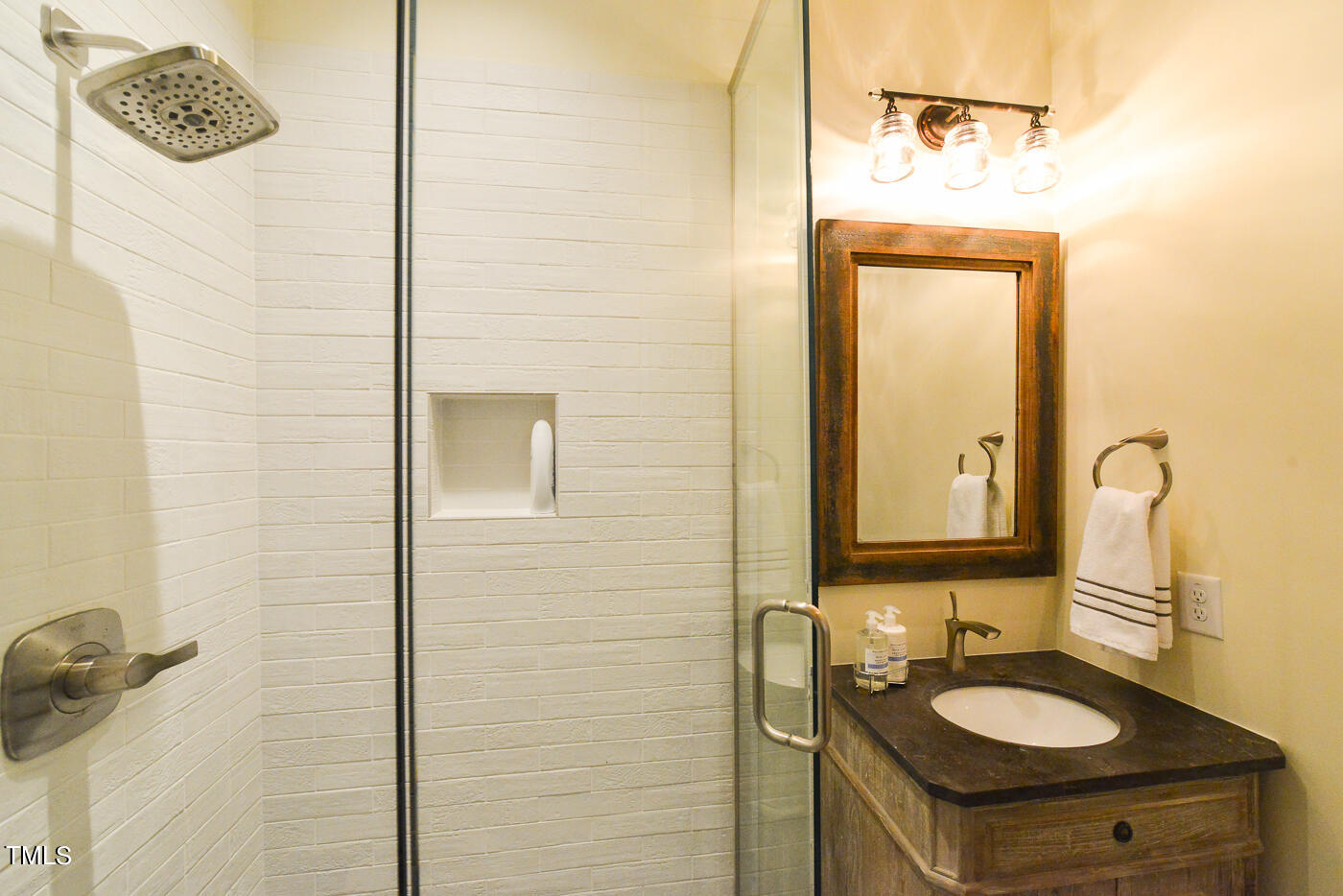 503 Cleveland Street Raleigh, NC 27605 - Photo 18 of 42 a bathroom with a sink a mirror and shower