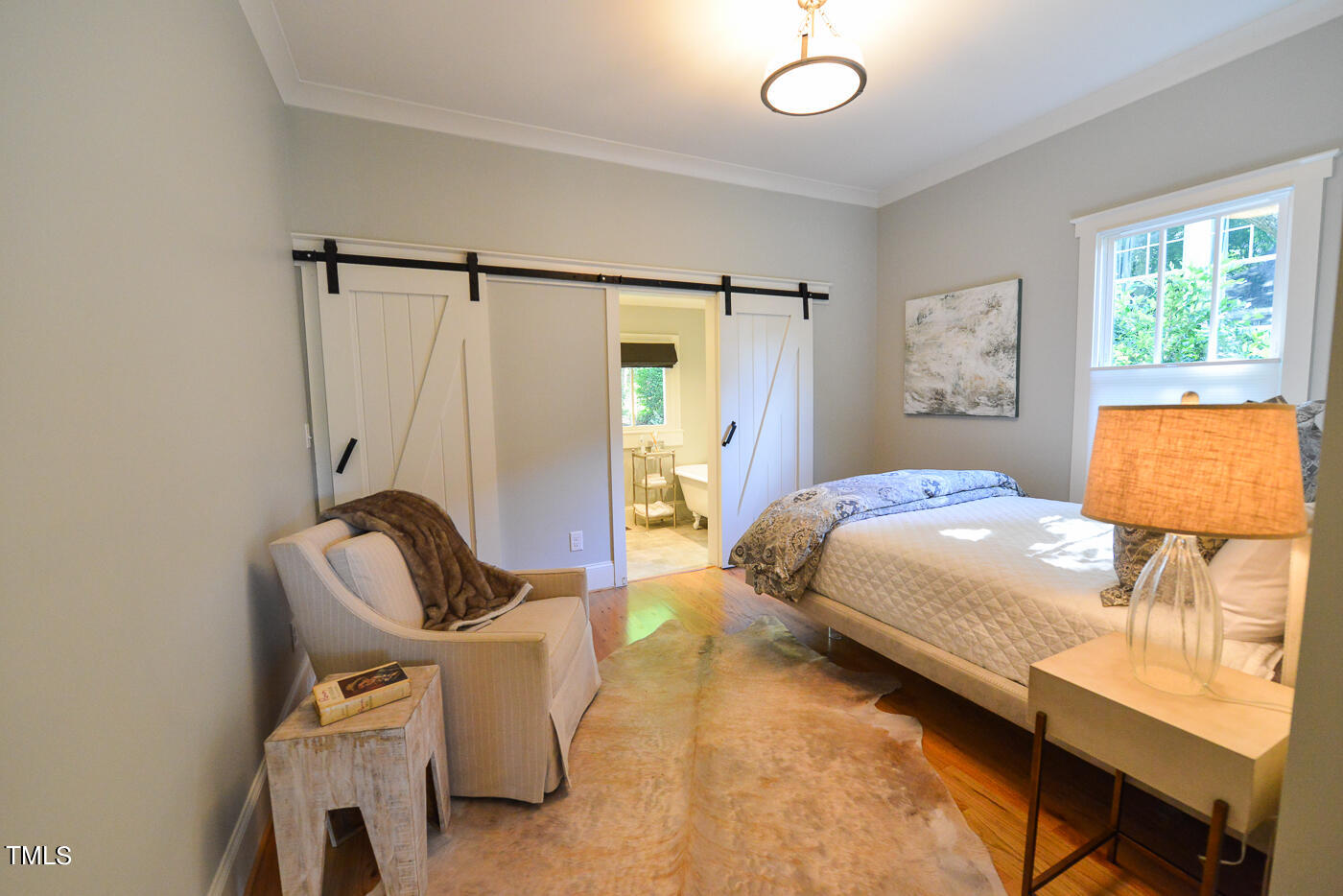 503 Cleveland Street Raleigh, NC 27605 - Photo 19 of 42 a bedroom with a bed chair and window