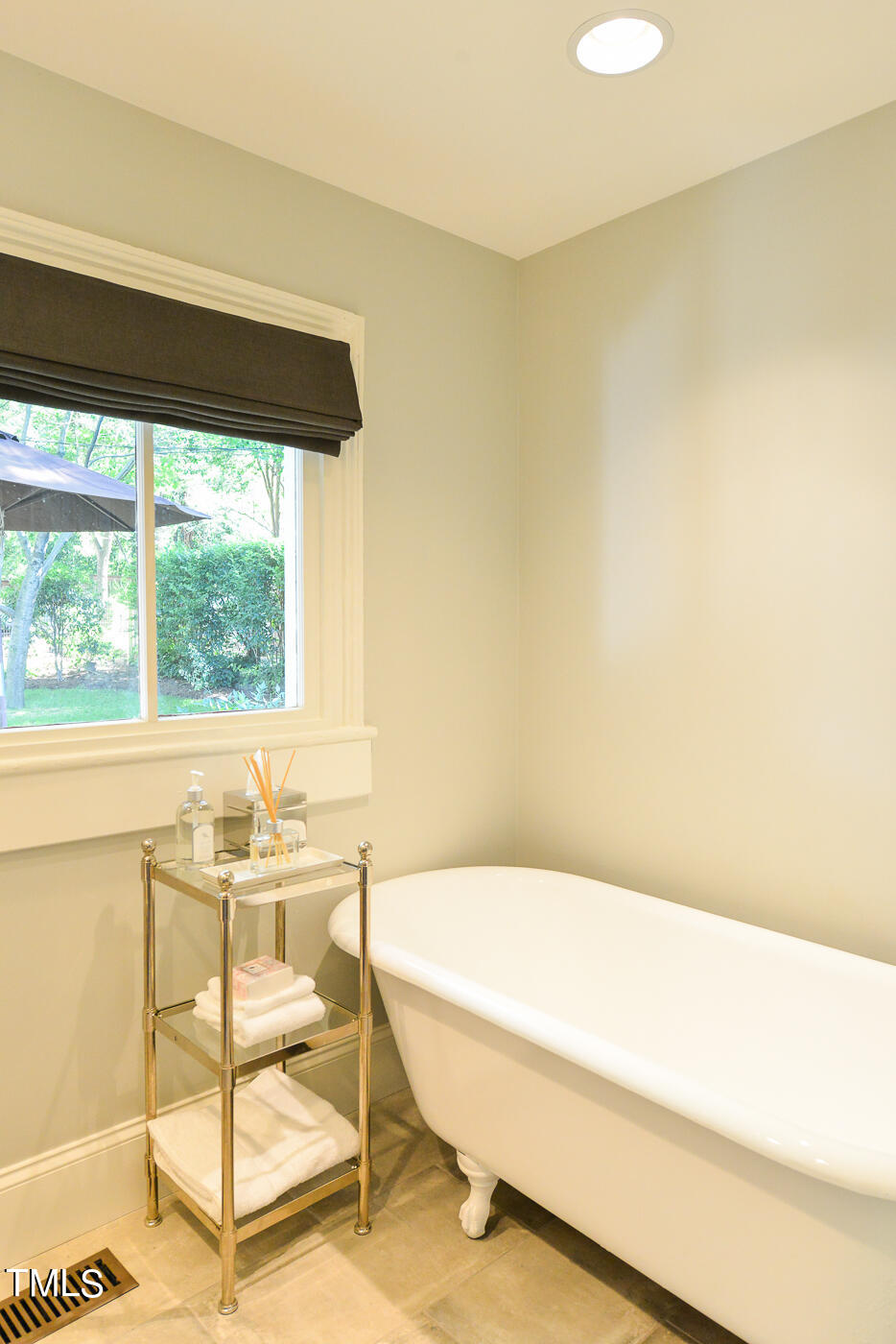 503 Cleveland Street Raleigh, NC 27605 - Photo 22 of 42 a bathroom with a bathtub and next to a window