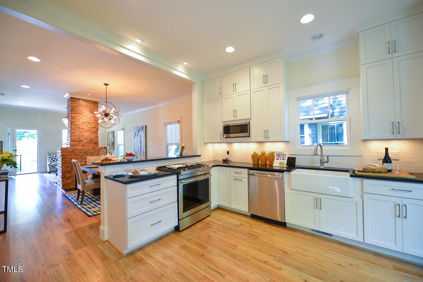 503 Cleveland Street Raleigh, NC 27605 - Photo 32 of 42 a kitchen with stainless steel appliances granite countertop a stove and a sink