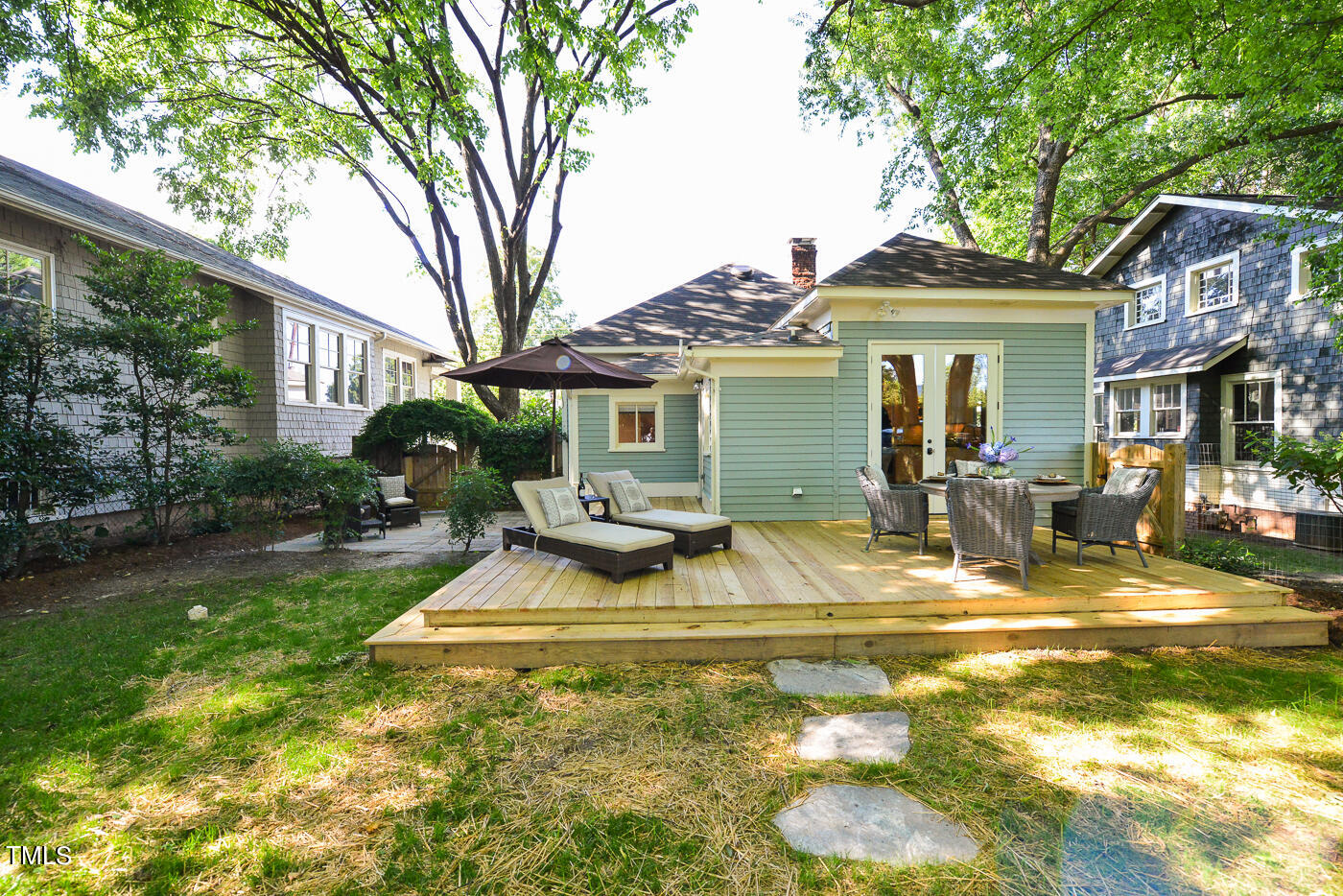 503 Cleveland Street Raleigh, NC 27605 - Photo 40 of 42 a view of a white house with a patio and a yard