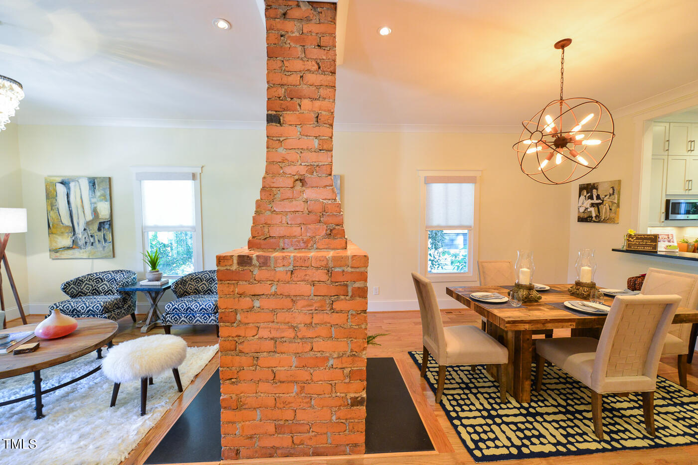 503 Cleveland Street Raleigh, NC 27605 - Photo 6 of 42 a dining room with chandelier fan and wooden floor