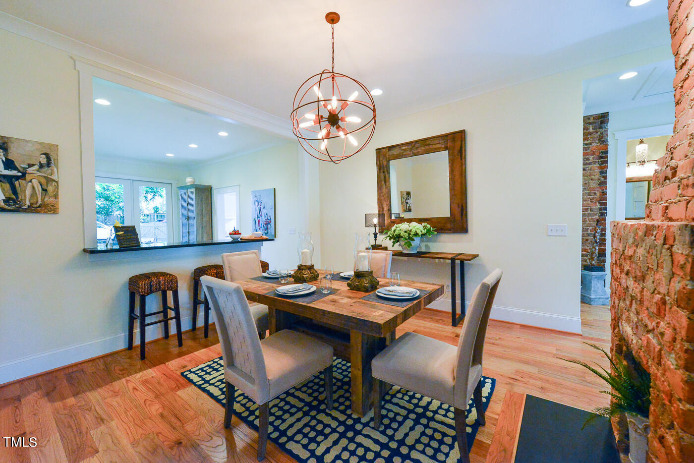 503 Cleveland Street Raleigh, NC 27605 - Photo 8 of 42 a dining room with furniture a rug and wooden floor