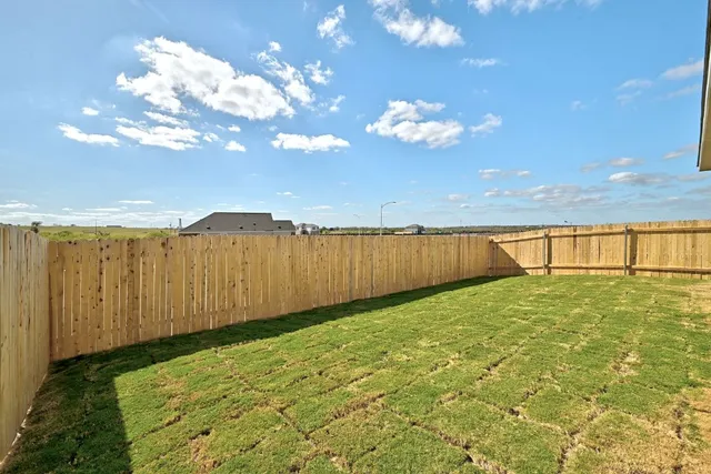 a view of a yard with an ocean view