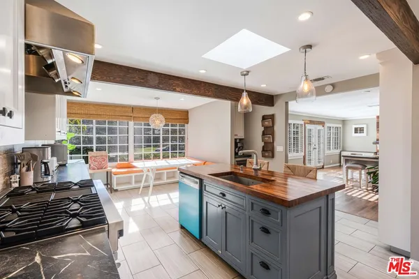 a kitchen with stainless steel appliances granite countertop a sink stove and cabinets