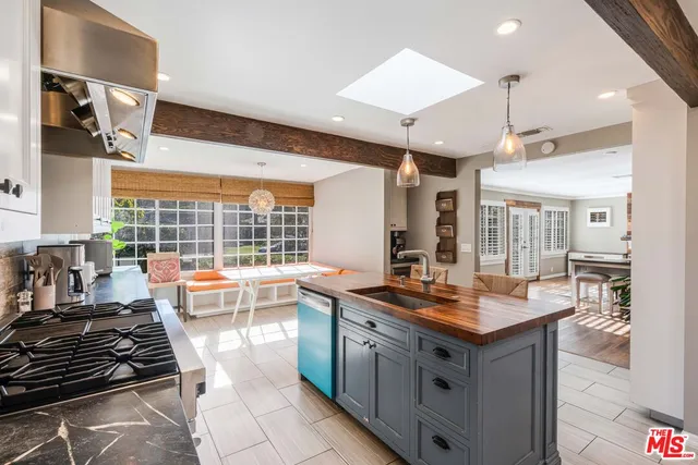 a kitchen with stainless steel appliances granite countertop a sink stove and cabinets