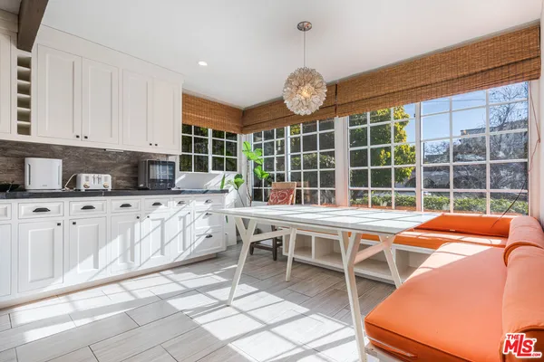 a view of a kitchen with a dining table and chairs