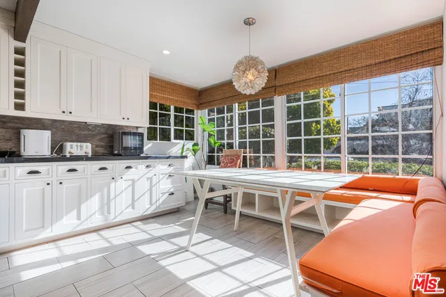 a view of a kitchen with a dining table and chairs