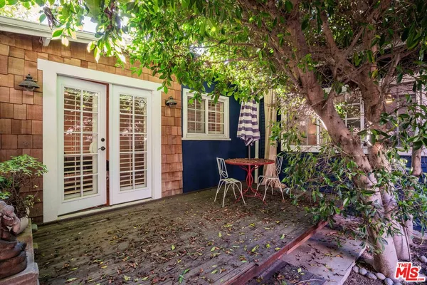 a bath room with a sink a toilet and a mirror