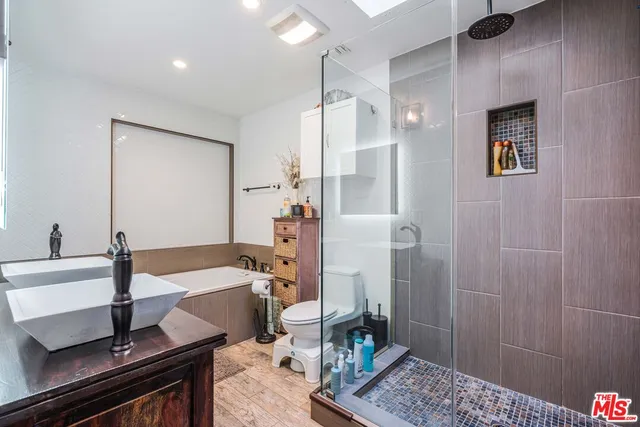 a bathroom with a tub sink and mirror