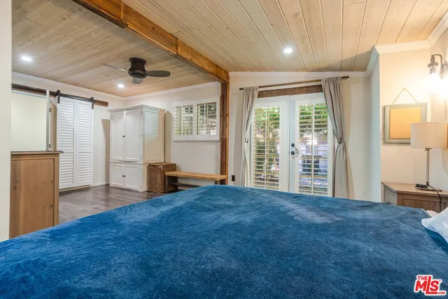 a bedroom with furniture and a window