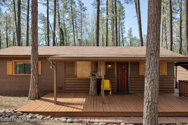 a view of a house with backyard and porch