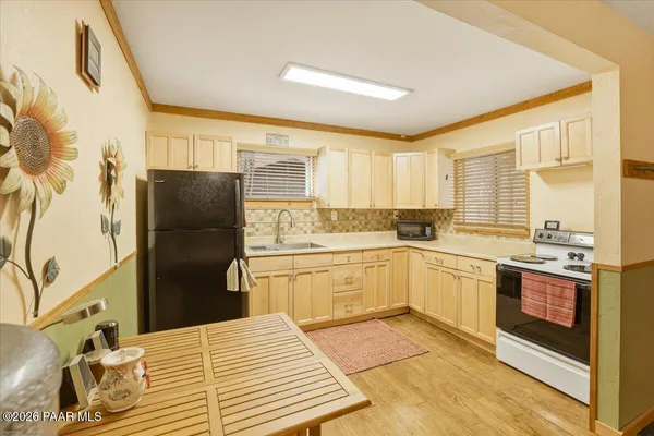a kitchen with a refrigerator stove and sink