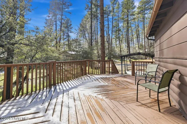 a view of balcony with wooden floor and outdoor seating