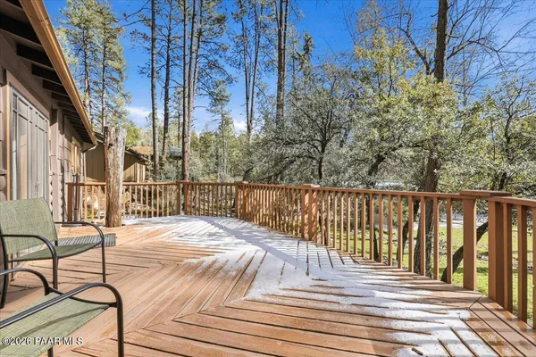 a view of a balcony with wooden floor and fence