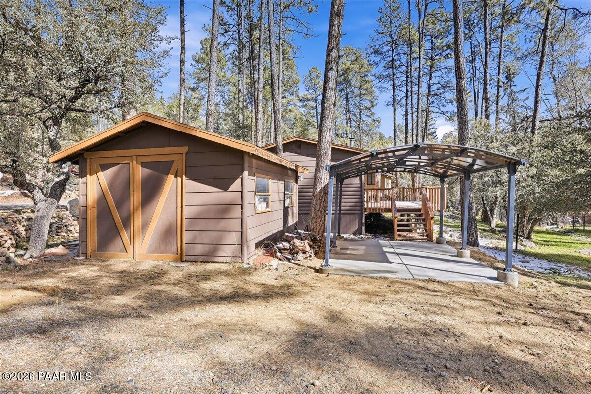 1383 West Boulder Road Prescott, AZ 86303 - Photo 21 of 21 a backyard of a house with table and chairs under an umbrella