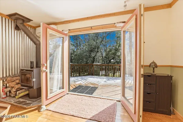 a view of a porch with a floor to ceiling window and wooden floor