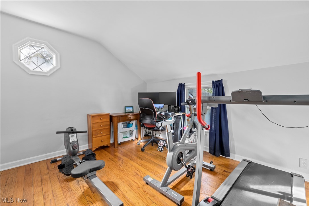 958 West River Road Vermilion, OH 44089 - Photo 31 of 40 Workout area with wood-type flooring and vaulted ceiling