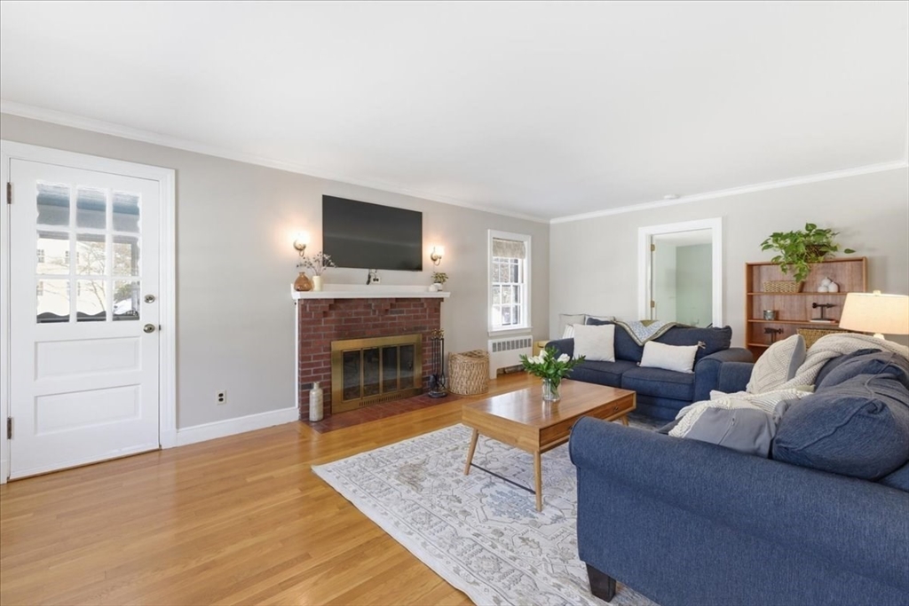 46 Park Street Dedham, MA 02026 - Photo 6 of 35 a living room with furniture a flat screen tv and a fireplace